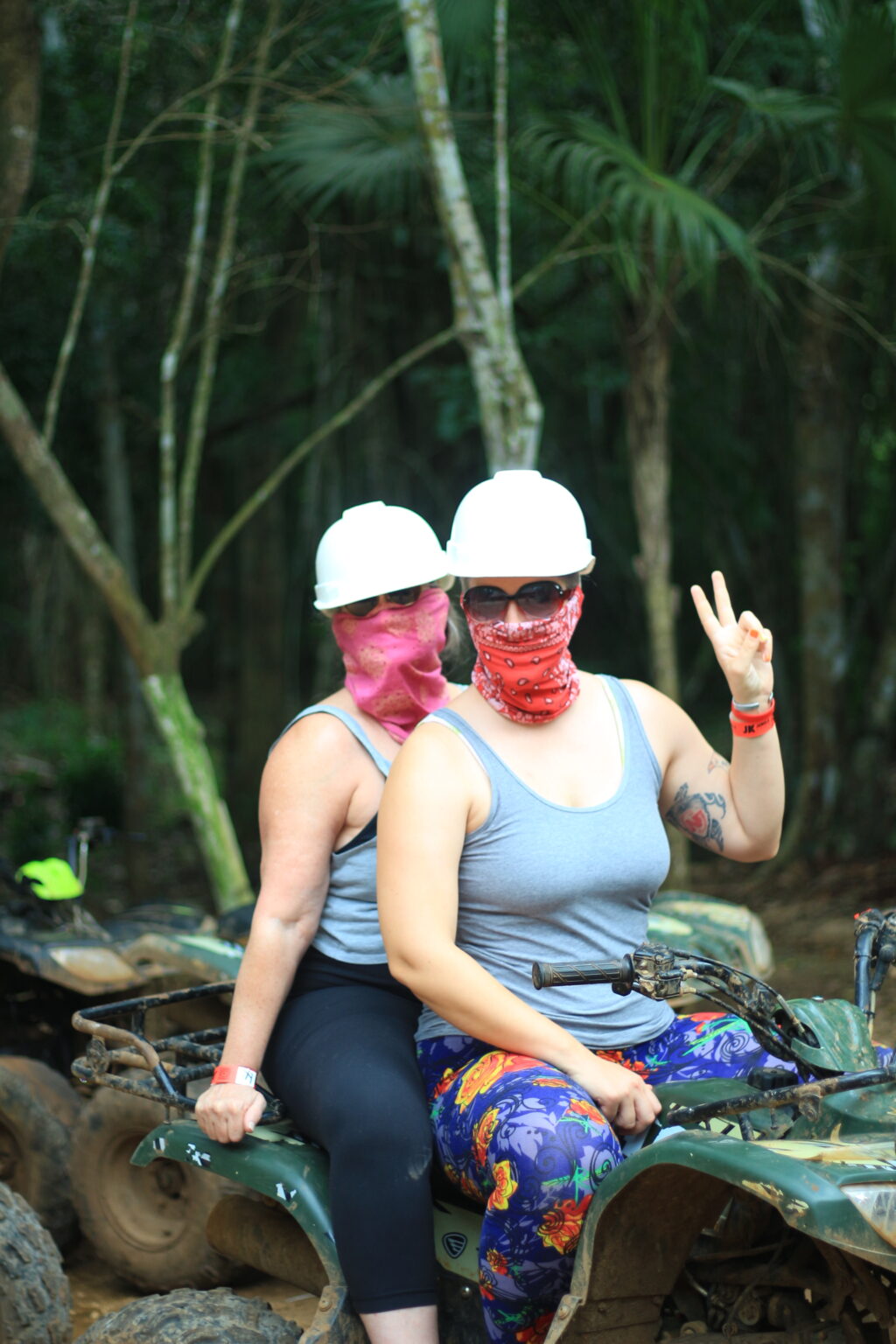 Two women in helmets on an ATV in the jungle near Cancun