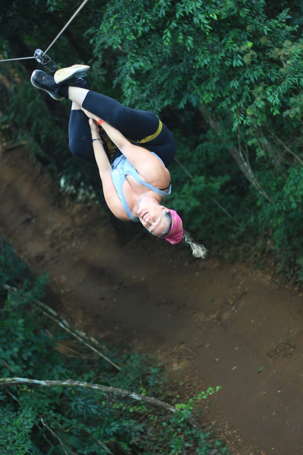 Zipliner hanging upside down on the line near Cancun