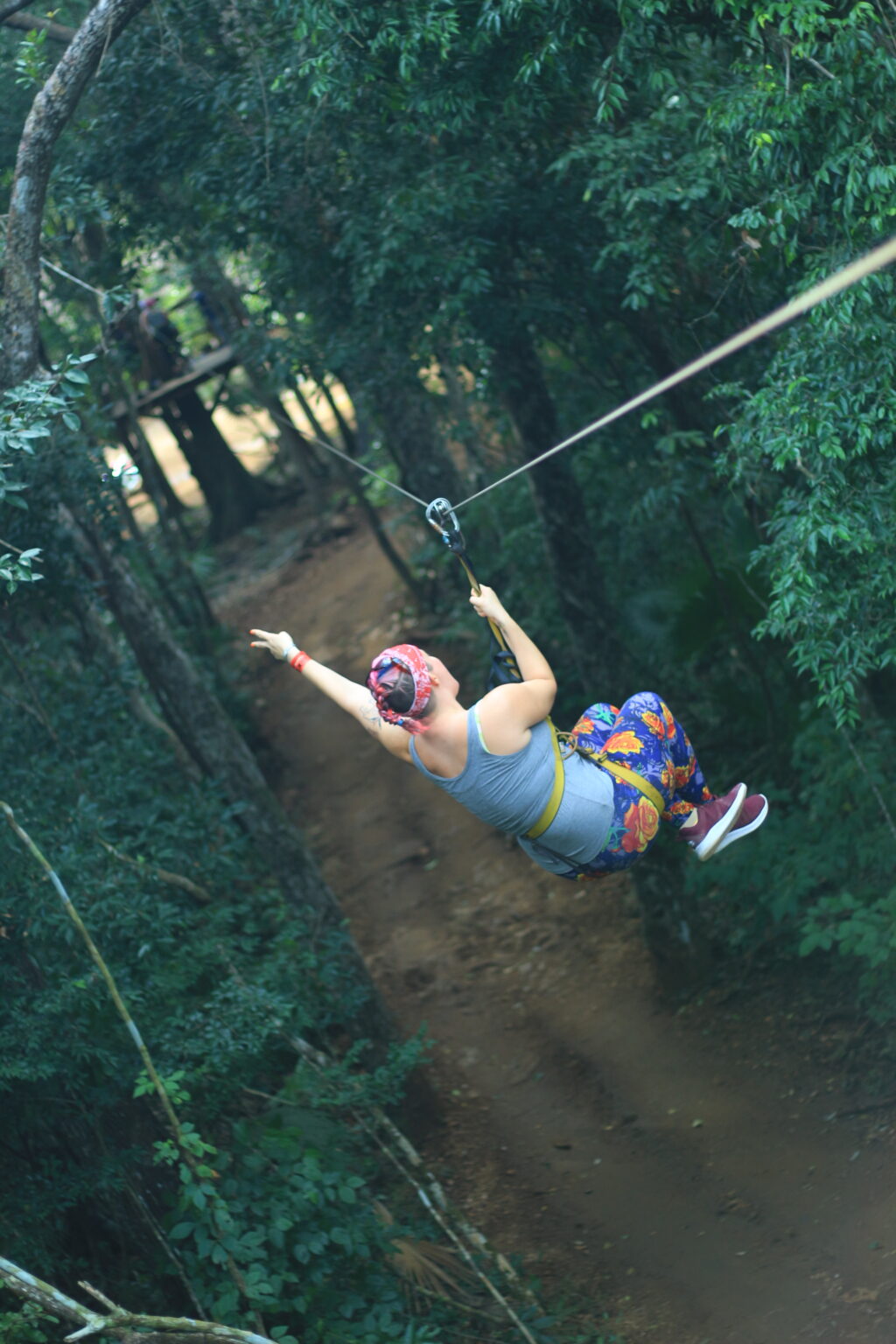 Zipliner flying through the forest canopy near Cancun