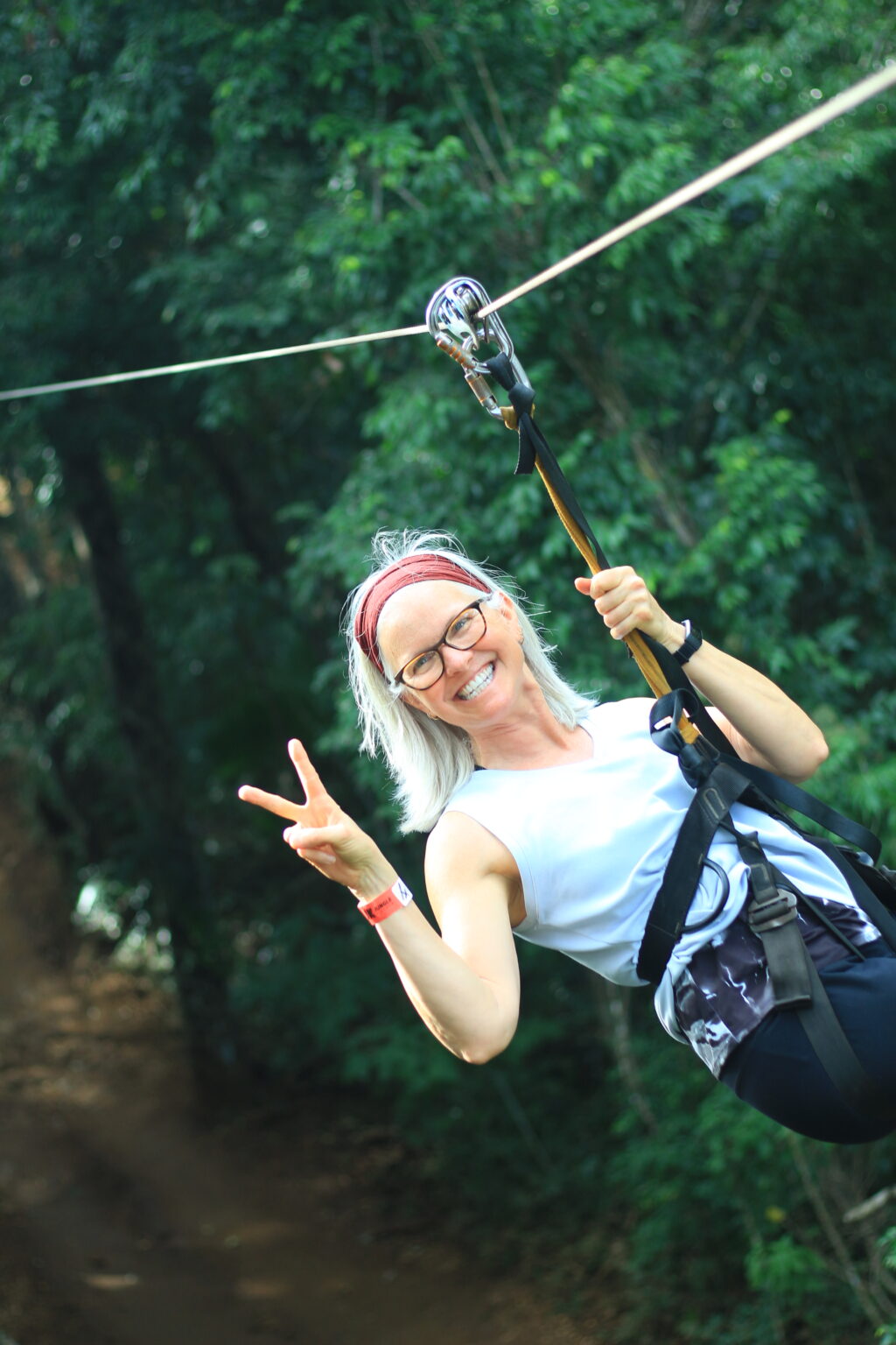 Woman ziplining through the jungle near Cancun