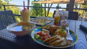 Salvadoran lunch plate and a fruit drink on a terrace table