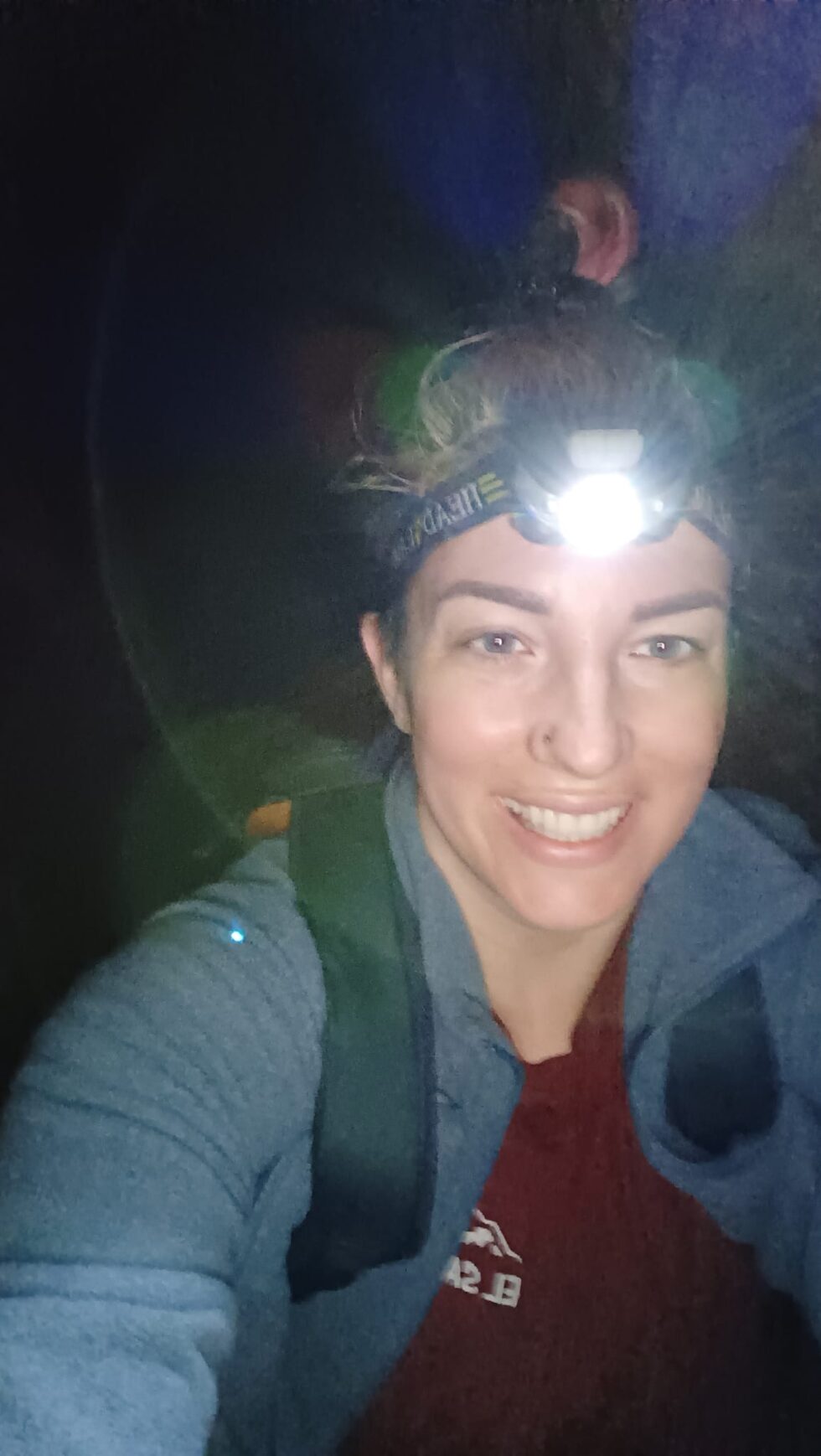 Hannah with a headlamp inside Hezekiah's Tunnel