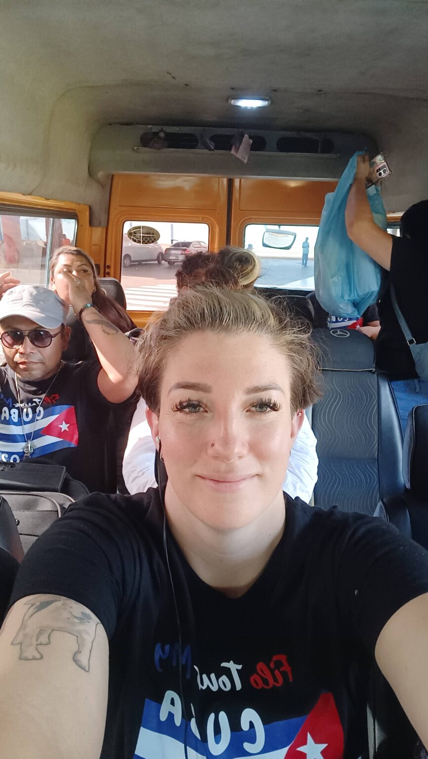 Hannah taking a selfie in a van with other travelers in Cuba