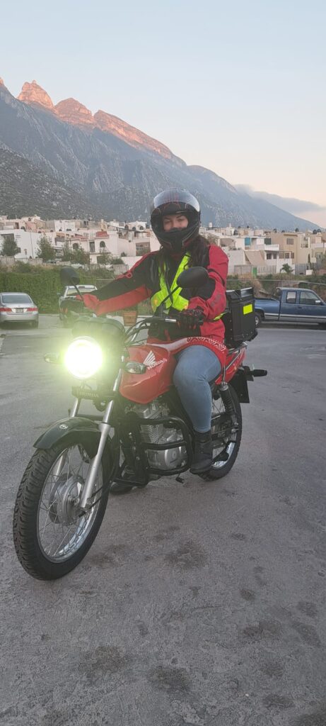 Woman on red Honda motorcycle