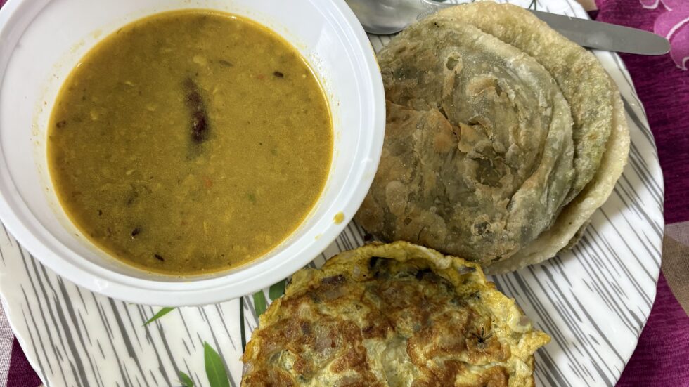 Breakfast of dal, paratha and an omelet in Kolkata