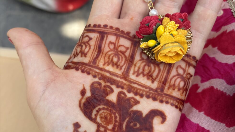 Henna design on a palm with a flower bracelet at a Bengali wedding in Kolkata