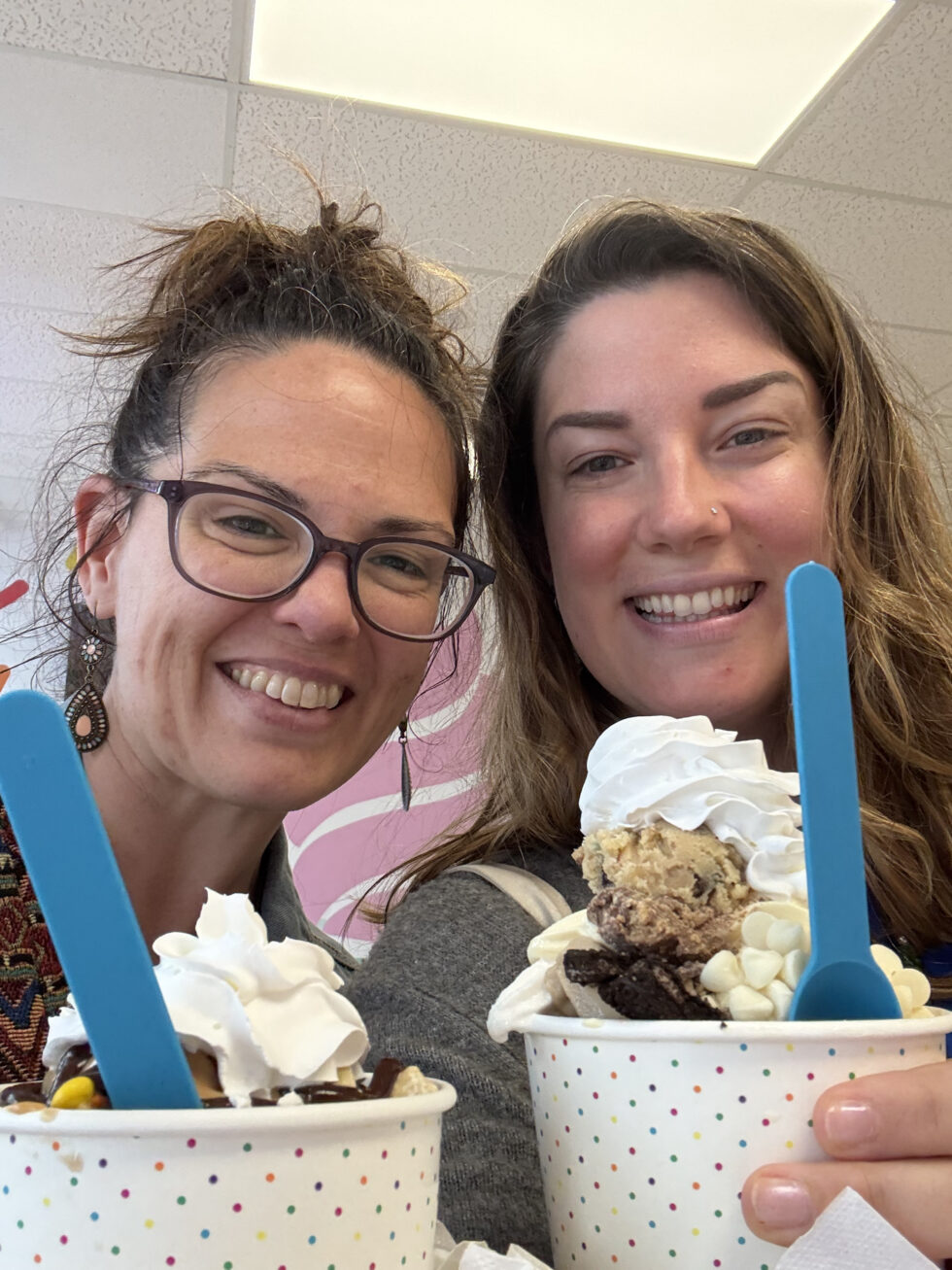Hannah and a friend holding ice cream sundaes during a visit to the U.S.