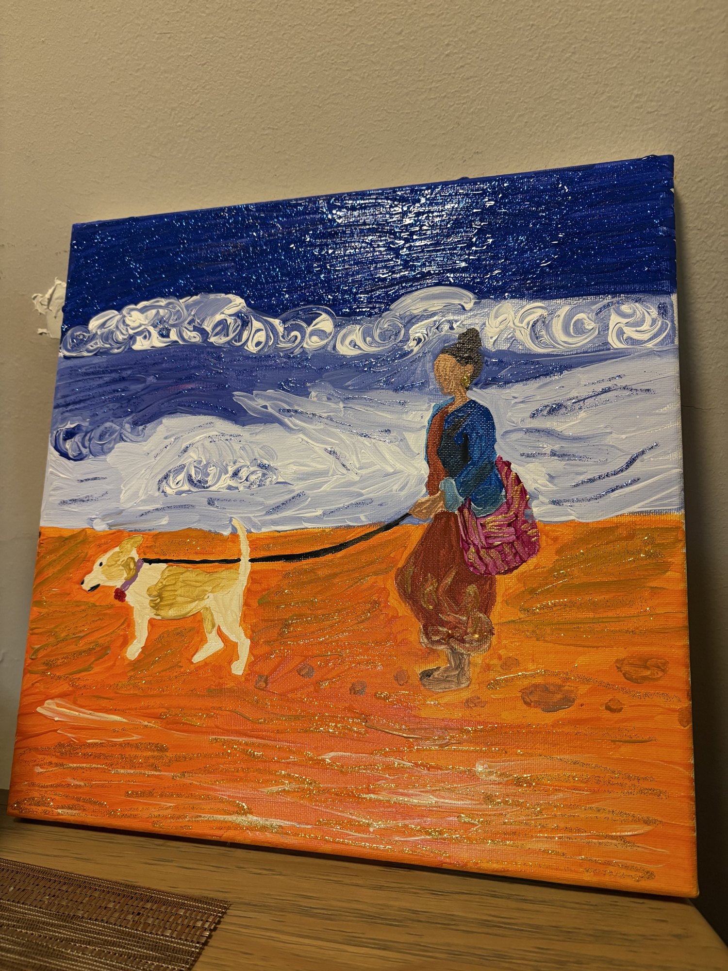 An acrylic painting of a woman walking a yellow dog along an orange beach under a blue and white sea.