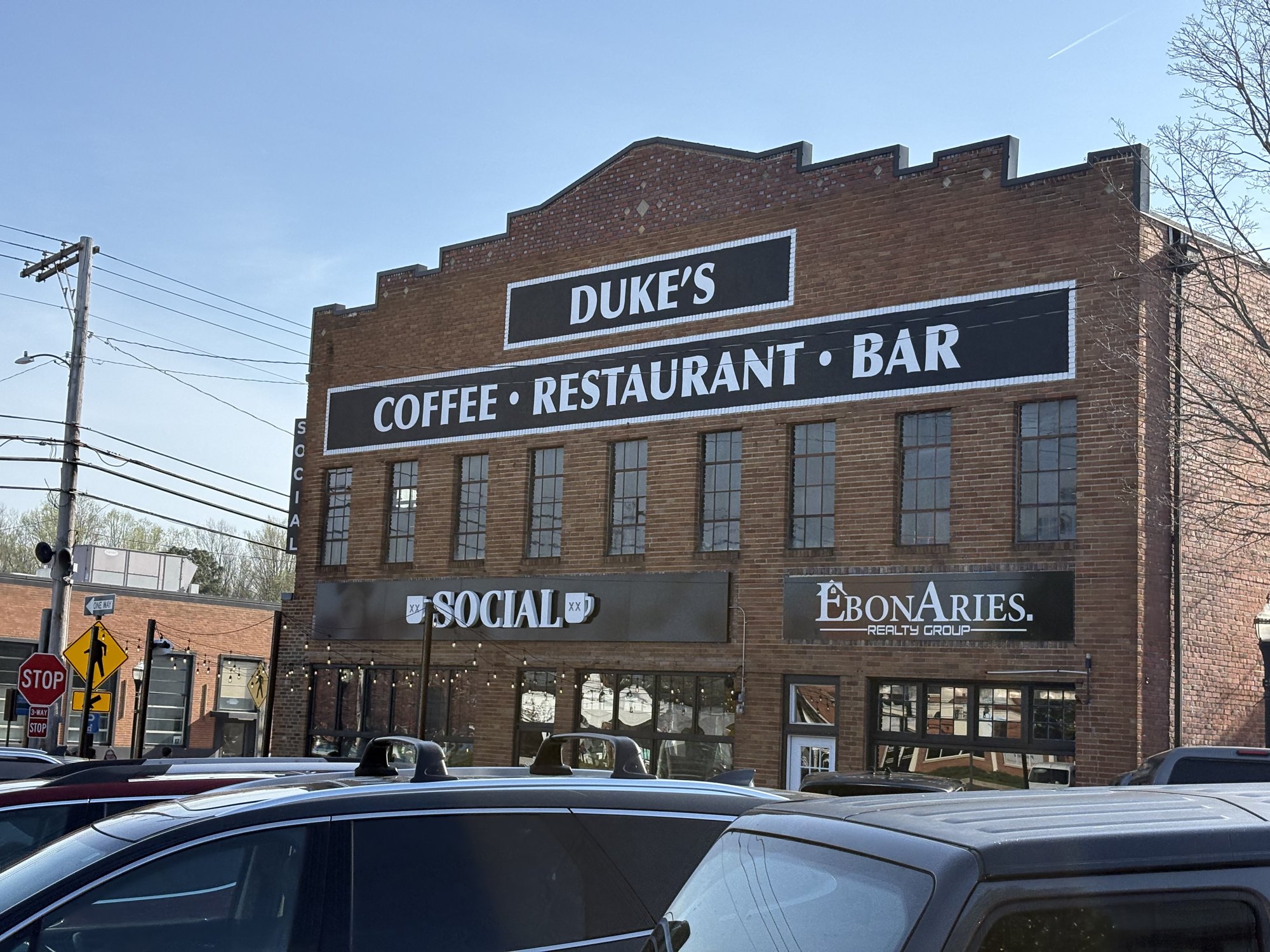 The brick Duke's building on a Leonardtown corner, its old sign reading Duke's Coffee Restaurant Bar with Social below it.
