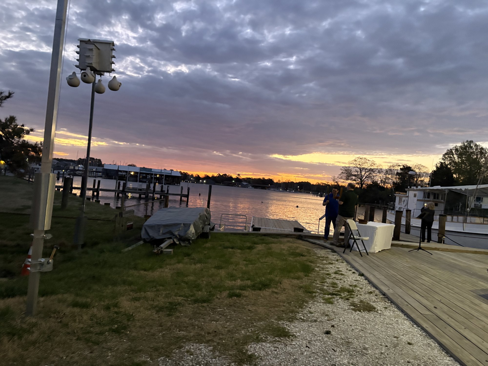 Sunrise over Breton Bay at Leonardtown Wharf, with boats moored along the dock.