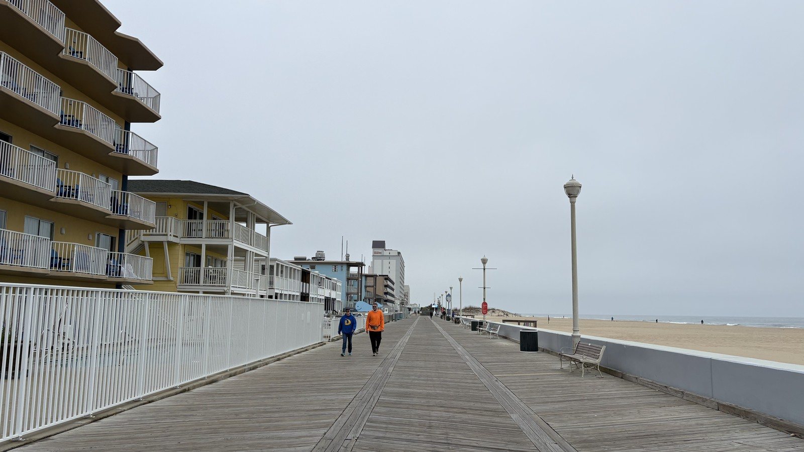 The Ocean City boardwalk stretching away into fog with almost nobody on it