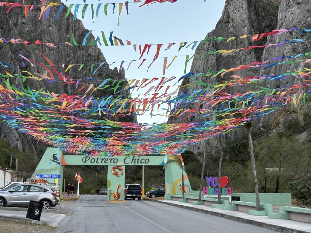 Colorful papel picado strung above the road at the El Potrero Chico park entrance