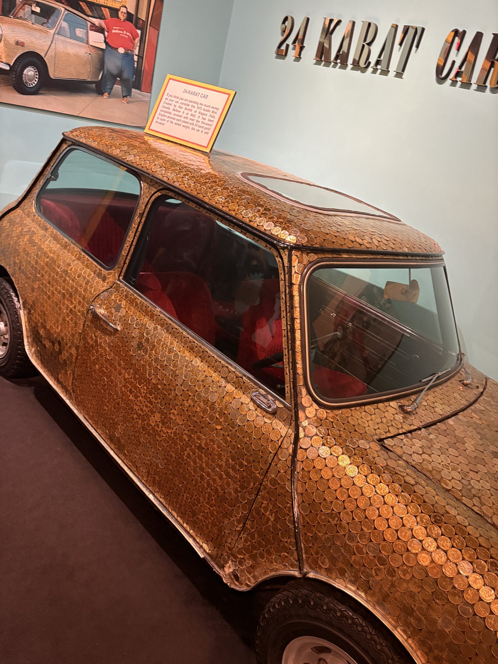 A Mini Cooper covered panel to panel in gold coins on display at Ripley's