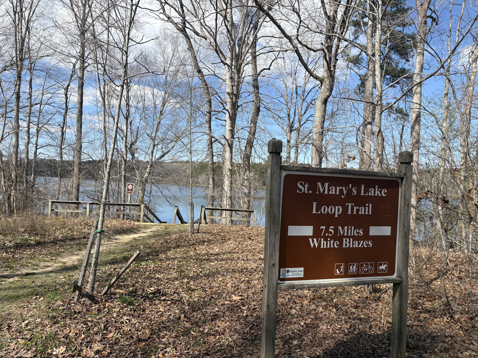 Brown trail sign reading St Mary's Lake Loop Trail, 7.5 Miles, White Blazes